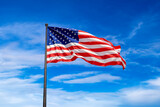 Fototapeta  - USA flag waving against sky