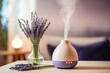 A vase of lavenders next to a diffuser, suitable for home decor