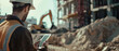 © Ai Studio - Construction worker in high-visibility gear uses a tablet on a building site.
