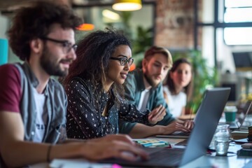 Poster - A diverse group of individuals actively engaged in working on their laptops at a table, Creative team working together on a laptop in an open-concept office, AI Generated