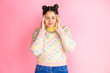 © Irene - Young beautiful woman wearing casual sweater over isolated pink background suffering from headache desperate and stressed because pain and migraine with her hands on head
