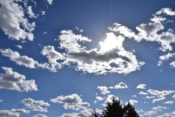 Wall Mural - Sun and Clouds in a Blue Sky