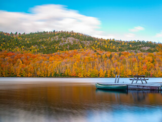 lac-du-missionaire, canada: oct.10 2022: morning fog on the lake of lac-du-missionaire with colorful