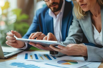 Poster - A man and a woman are engaged in examining the contents of a tablet device, Focused business professionals working together on a digital tablet, AI Generated