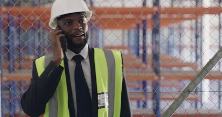 Poster - Phone call, engineer and construction worker with discussion on site with building plans and safety gear. Black man, helmet and smartphone in communication on technology and maintenance by warehouse
