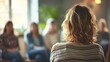 Person from behind at a blurred group therapy session