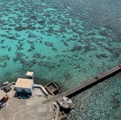 Canvas Print - Aerial view of a pier on a turquoise sea on a sunny day