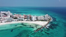 Cancun Coastline With Clear Blue Waters And Bustling Beachfront, Aerial View