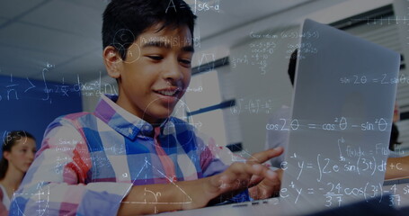 Poster - Image of mathematical equations over schoolboy using laptop in classroom