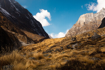 Canvas Print - Rocky mountainside under a cloudy sky with snow, a scenic landscape.