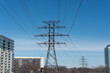 transmission towers and buildings on a blue sky