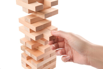 Canvas Print - Woman playing Jenga on white background, closeup