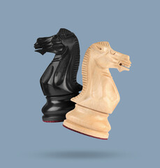 Sticker - Wooden chess knights in air on greyish blue background