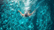 © Fokke Baarssen - Top View Male Swimmer Swimming in Swimming Pool. Professional Determined Athlete Training for the Championship, using Butterfly Technique. Top View Shot