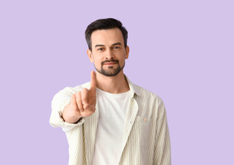 Wall Mural - Handsome man on lilac background