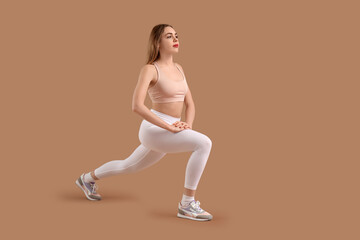 Sticker - Beautiful young woman in sportswear training on brown background