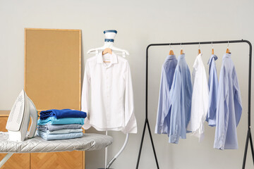 Wall Mural - Ironing board and rack with clothes in interior of living room