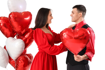 Wall Mural - Young couple with heart-shaped balloons on white background. Valentine's Day celebration