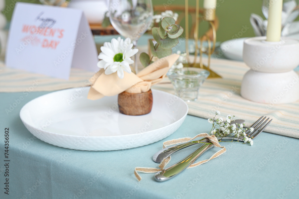 Simple table setting with silver cutlery for International Women's Day celebration, closeup