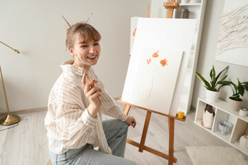 Poster - Female artist painting on canvas in workshop