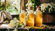Photography of a homemade elderflower cordial in glass bottles with fresh flowers
