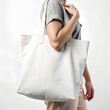 Woman holding reusable cotton linen eco organic fabric canvas blank tote bag on white background for mockup