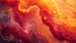 Closeup of a marbled effect with rich shades of red and yellow paint merging into one another in an enchanting display.