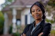 © Christiankhs - Portrait of a beautiful young female African American real estate agent standing outdoors.