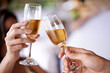 © Hover/peopleimages.com - Hands, couple and glass with champagne to toast, celebrate and anniversary with date for bonding. Closeup, relationship and cheers for love with bubbles for romance on vacation, support and care.