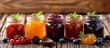 Variety of homemade jams and fruit preserves in glass jars on wooden table