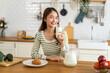 Portrait of beauty healthy asian woman smiling and having protein breakfast drinking and hold glasses of milk of fresh milk, nutrition,calcium and vitamin,dairy product in kitchen at home.Diet concept