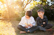 © Austockphoto - Two happy young boys holding fluffy yellow chicks in the backyard