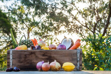 Wooden Box Of Colourful, Fresh Fruit And Vegetables On Wooden Table With Green Bokeh Background