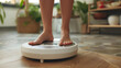 A woman stands on a digital scale in her living room.