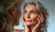 © Hitesh - Happy 50s middle aged mature woman touching facial skin looking at camera pampering in mirror. Old healthy dry skin care beauty concept, skin treatment, cosmetics and anti age plastic, Generative AI