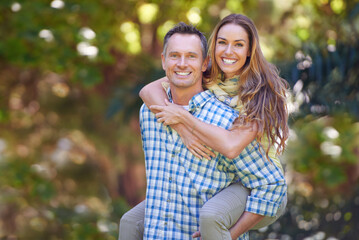 Canvas Print - Mature couple, portrait and woman on piggyback, outside and garden for anniversary. Affectionate, happy and Autumn sun for loving, smile and romantic relationship for Canadian husband and wife