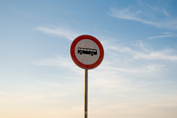 No entry for bus traffic sign, isolated sunset sky.