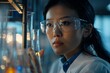 Asian scientist in a white robe wearing glasses in the laboratory. 