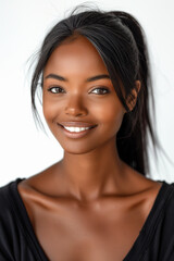 High quality vertical portrait of beautiful young adult black woman in black clothes smiling on white background. NIce smile and white teeth dental advertising.