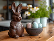 Chocolate bunny figurine beside speckled Easter eggs in a bowl. Home interior with spring decor concept for design