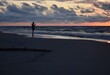 Walking on the beach by the Baltic Sea. Silhouette of a person