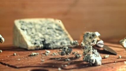 Sticker - Super slow motion blue cheese falls on a wooden table. Filmed on a high-speed camera at 1000 fps. High quality FullHD footage