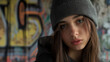 © Ron - portrait of a  woman wearing a grey beanie hat on graffiti  background.  Model beanie pose for mockup template