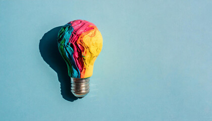 Wall Mural - Colorful Creative idea concept with lightbulb made from colorful paint, copyspace on a side