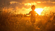 A childs silhouette running joyfully through a field of tall grass with the sun setting behind.