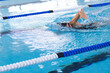 © wavebreak3 - Caucasian female athlete swimmer swimming laps in a pool, with copy space