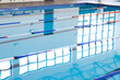 Empty lanes in a serene indoor swimming pool await swimmers