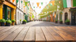 empty wooden table, blurred bokeh background of decorated street with festival flags, st. patrick's day