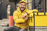Fototapeta Tulipany - Pizza delivery man holding delivery box with pizza