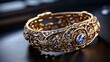 © Creatorbin - Beautiful gold bracelet with blue stones on a black background close up